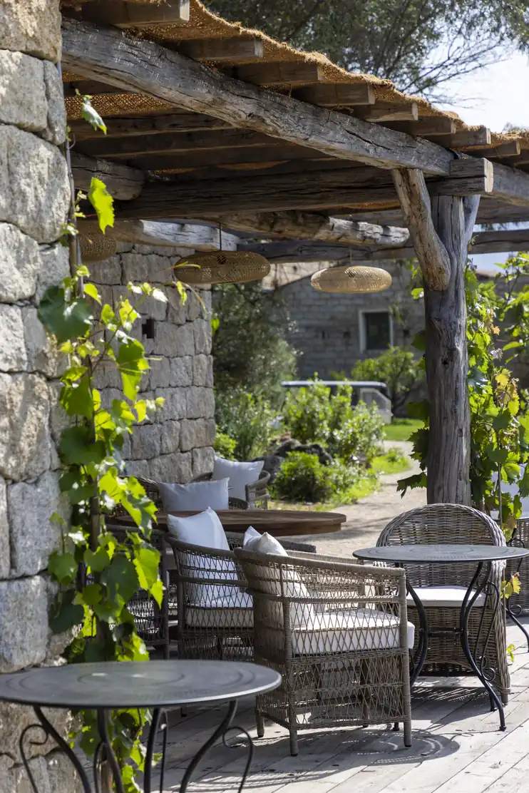 Terrasse ombragée sous une vigne grimpante au Hameau de Saparale.